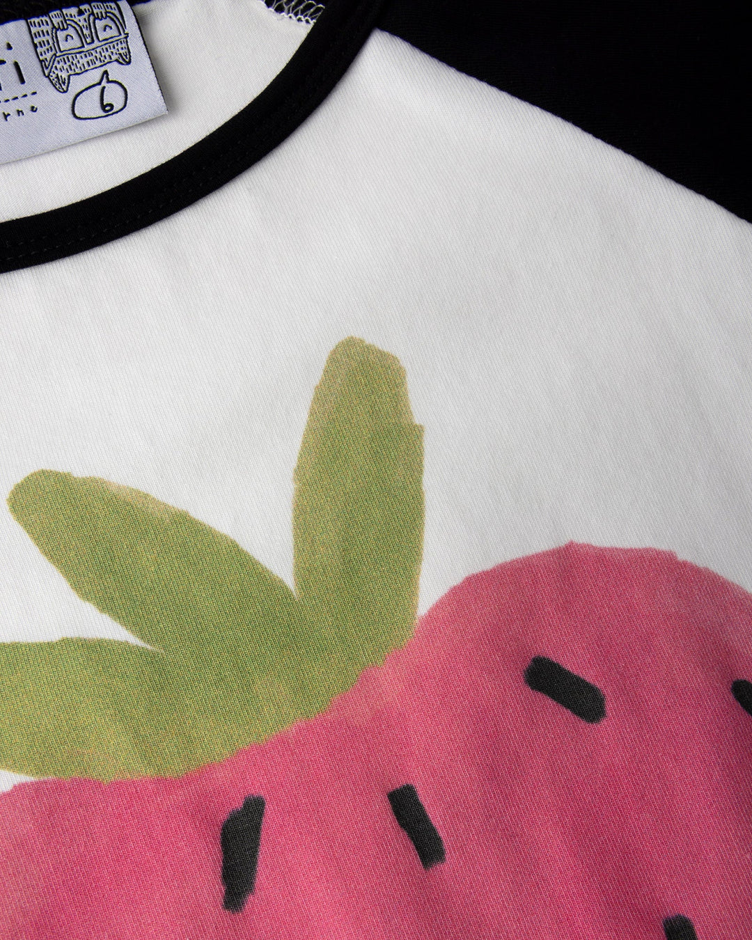 Close up of the Happy Strawberry Tee print in white and black