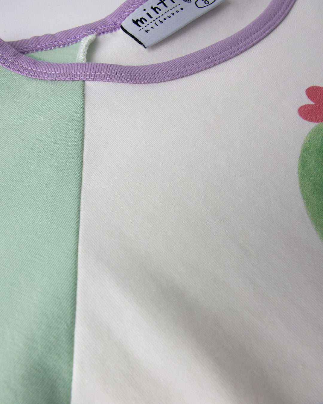 Close up detail of the Skate Cactus Tee in white and mint