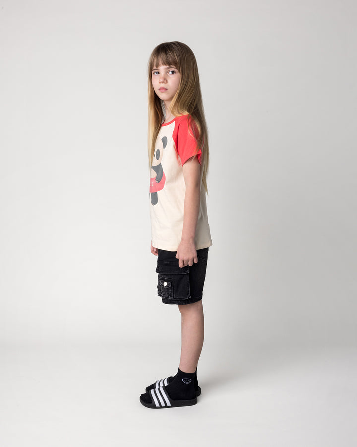 Kid wearing the Swimming Panda Tee in stone and watermelon, side view