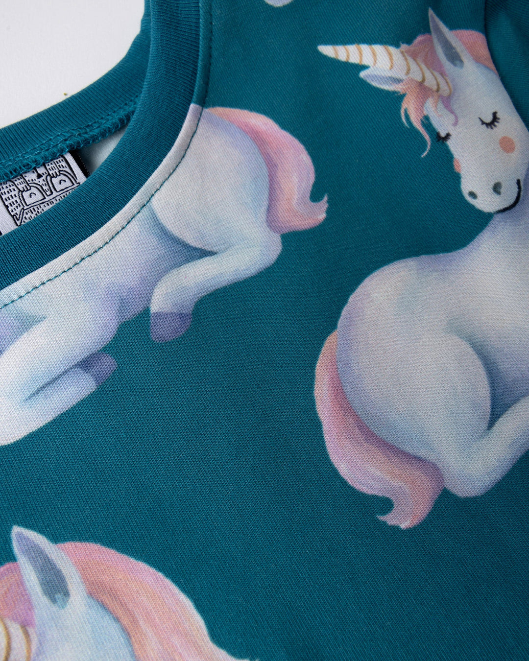Close up of the Daydreaming Unicorn Dress print in teal