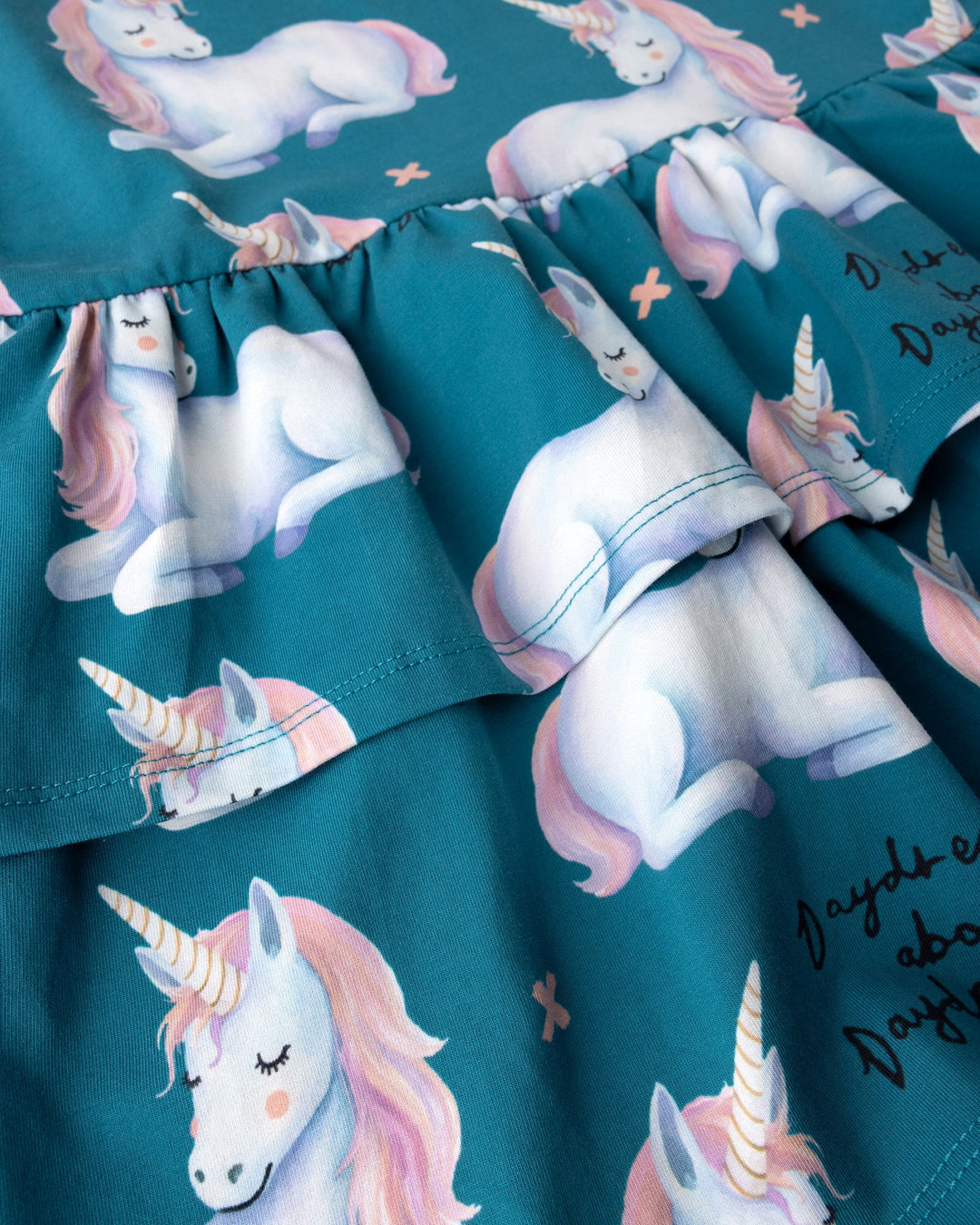 Close up of the Daydreaming Unicorn Dress print in teal