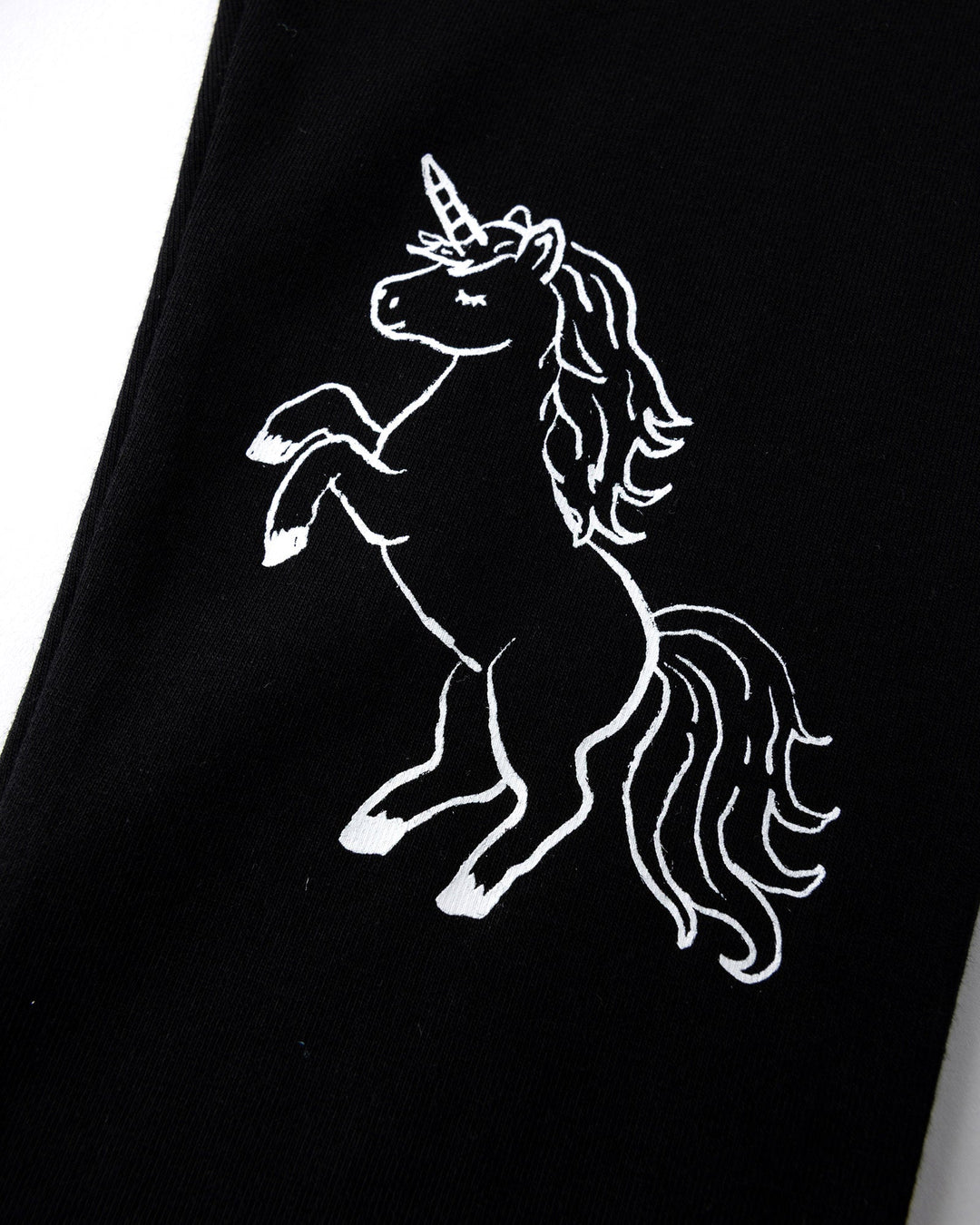 Close up of the Hello Unicorn Tights print in black