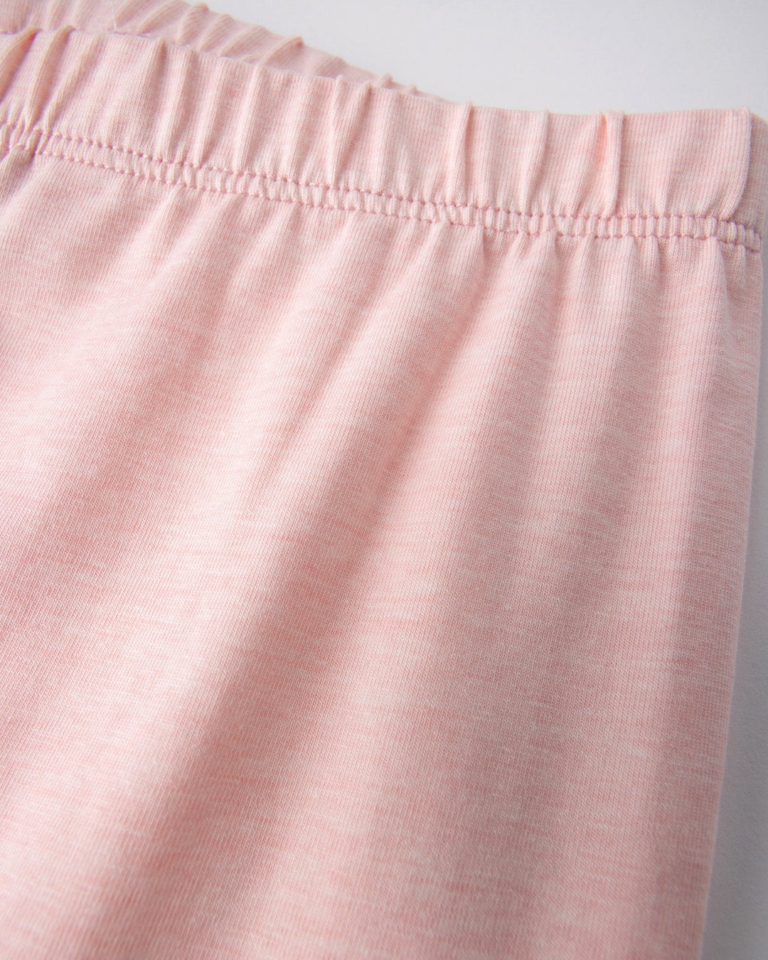 Close up detail of the Happy Strawberry Tights in pink marle