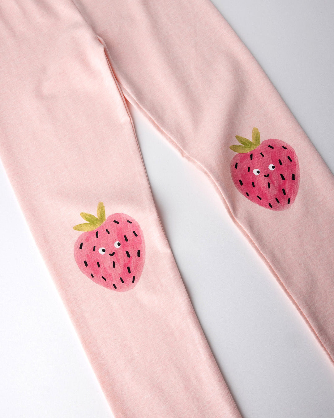 Close up of the Happy Strawberry Tights print in pink marle
