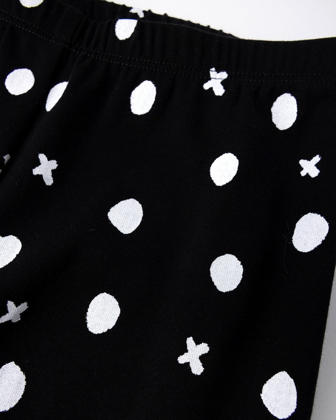 Close up of the Spotty Tights print in black