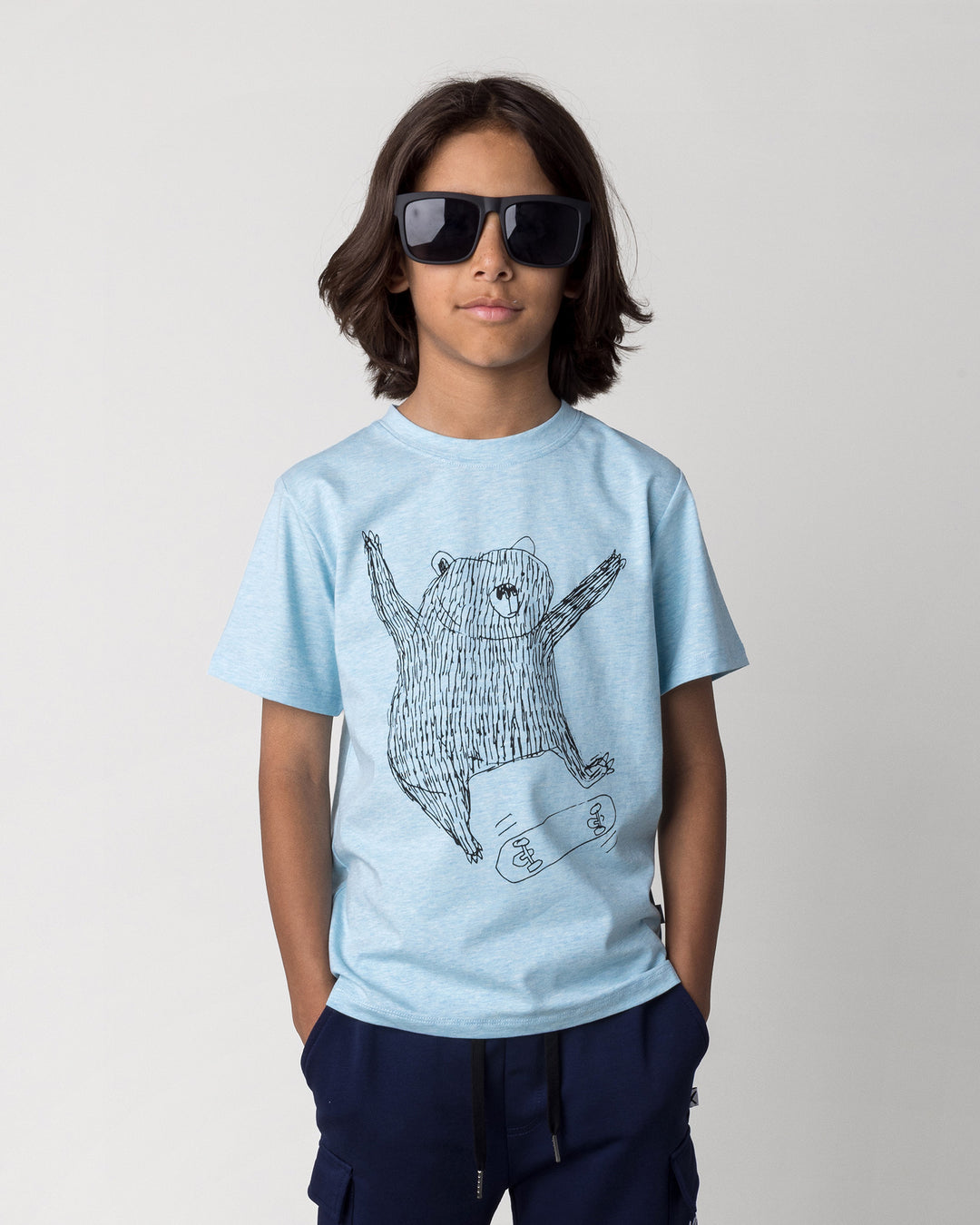Close up of the Boarding Bear Tee in blue marle on a kid, front view