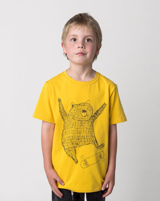 Close up of the Boarding Bear Tee in mustard on a kid, front view