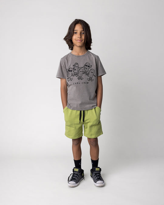 Kid wearing the Cool Crew Tee in grey wash with the Track Short in lime, front view