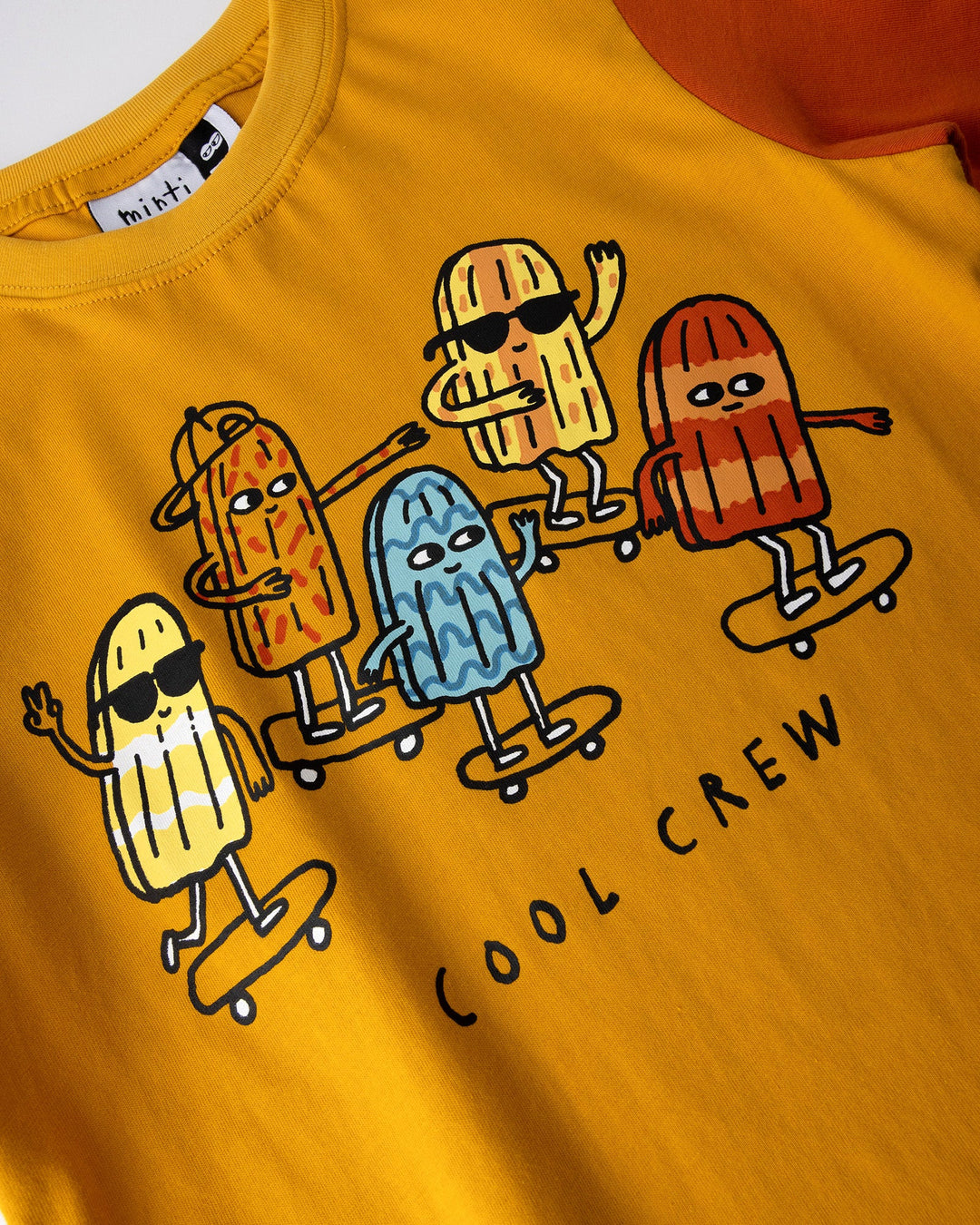 Close up of the Cool Crew Tee print in mustard, midnight and orange