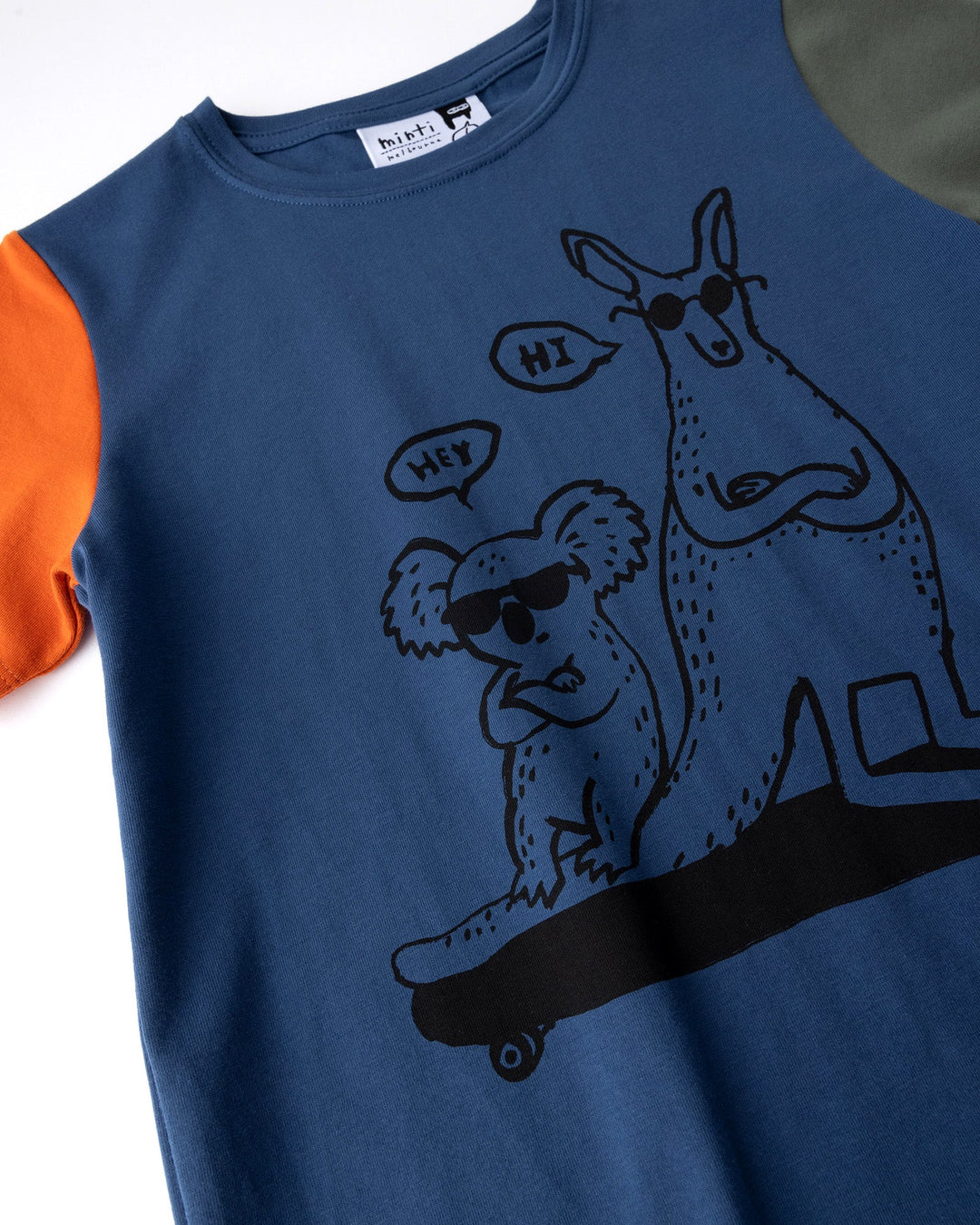 Close up of the Chill Mates Tee print in midnight, orange and forest