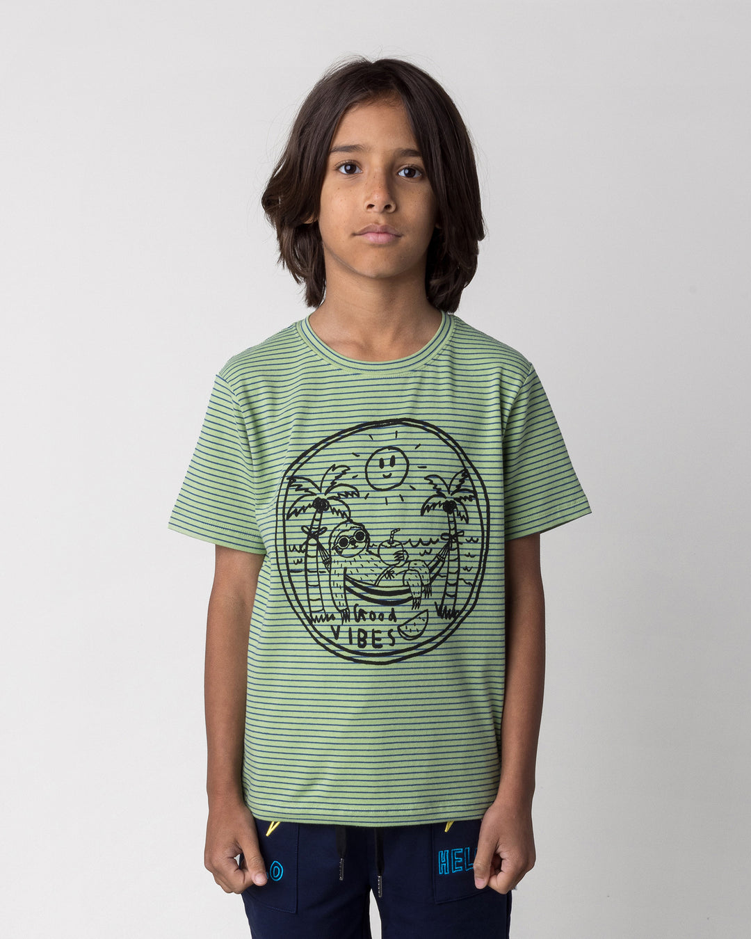 Close up of the Chill Sloth Tee in lime stripe on a kid, front view