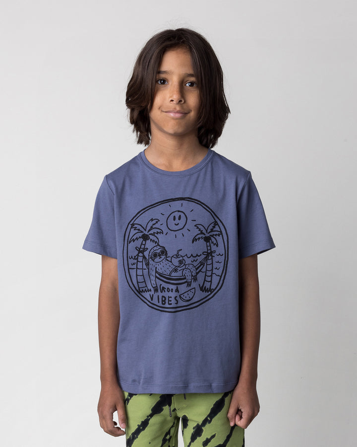 Close up of the Chill Sloth Tee in muted blue on a kid, front view