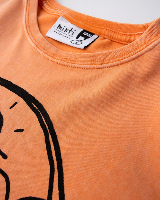 Close up of the Chill Sloth Tee print in orange wash