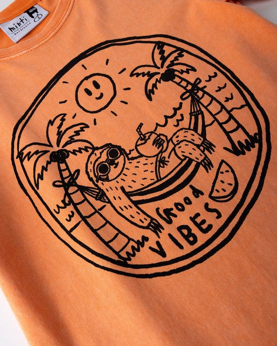 Close up of the Chill Sloth Tee print in orange wash