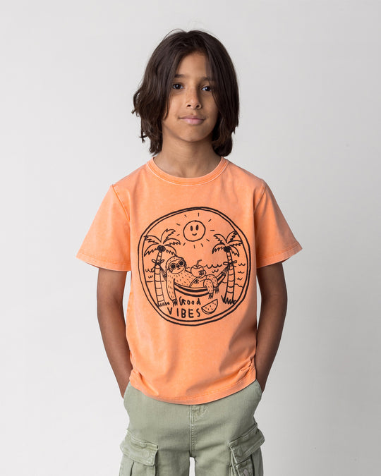 Close up of the Chill Sloth Tee in orange wash on a kid, front view