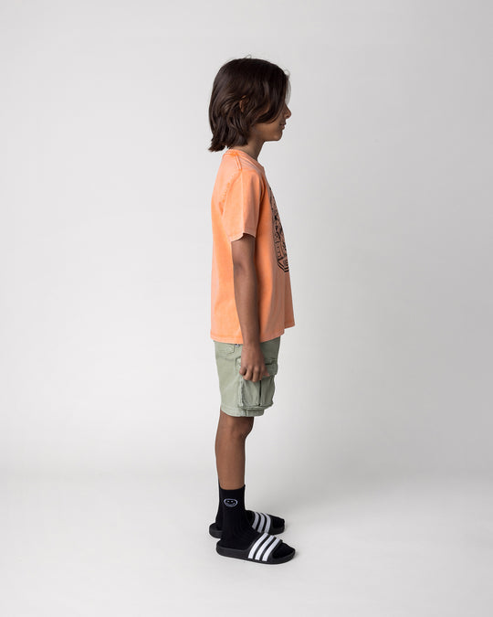 Kid wearing the Chill Sloth Tee in orange wash, side view