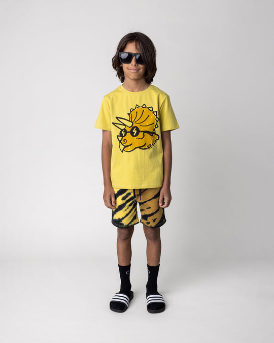 Kid wearing the Cool Dino Tee in zest with the Duo Tie Dye Short in lemon and rust, front view
