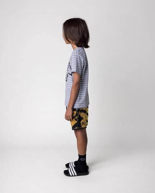 Kid wearing the Cool Pterodactyl Tee in grey stripe with the Duo Tie Dye Short in lemon and rust, side view
