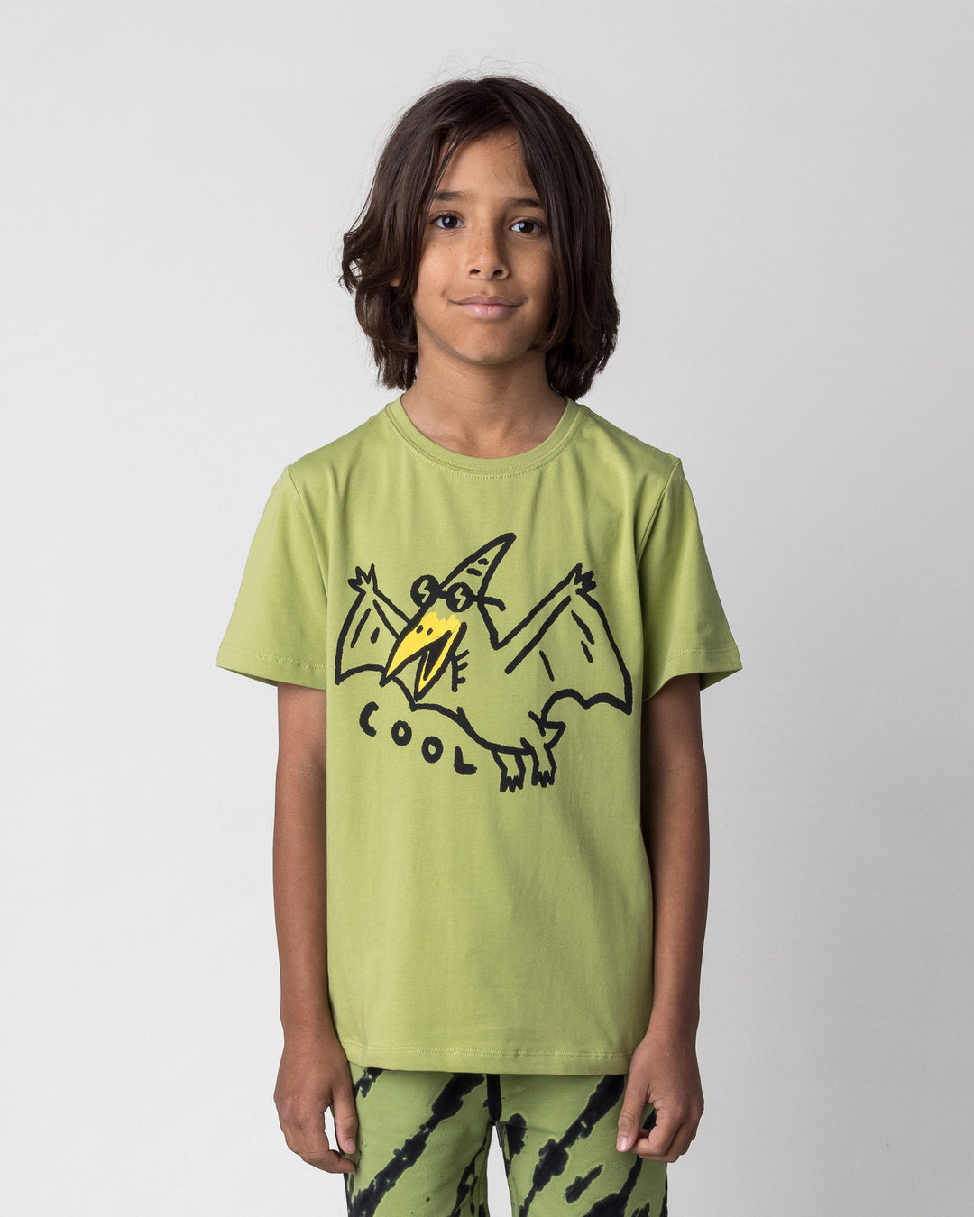 Close up of the Cool Pterodactyl Tee in lime on a kid, front view