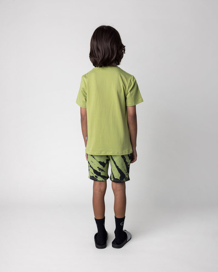 Kid wearing the Cool Pterodactyl Tee in lime with the Strike Short in lime, back view