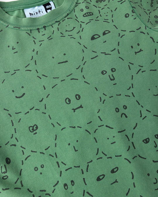 Close up of the Different Faces Tee print in turf wash