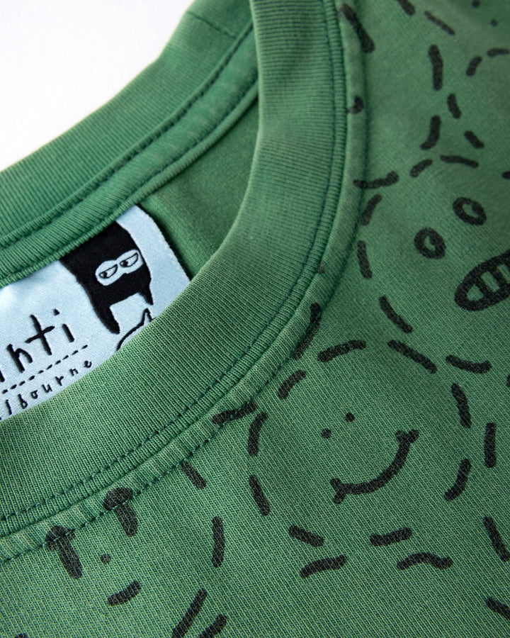 Close up detail of the Different Faces Tee in turf wash