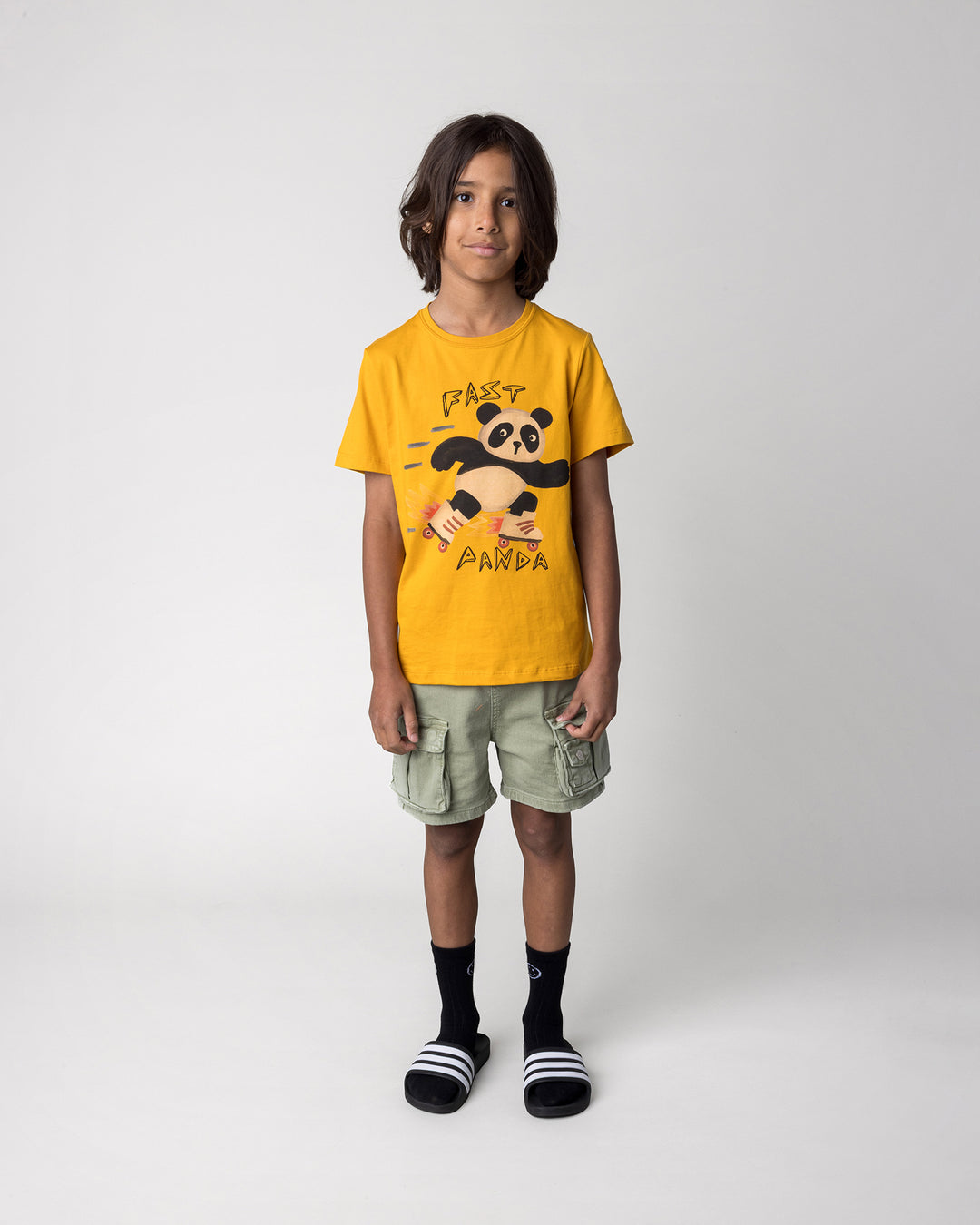 Kid wearing the Fast Panda Tee in mustard, front view