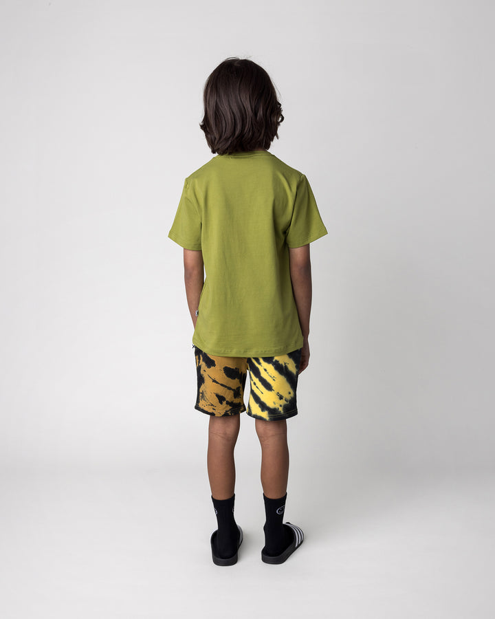 Kid wearing the Greetings Bat Tee in olive with the Duo Tie Dye Short in lemon and rust, back view