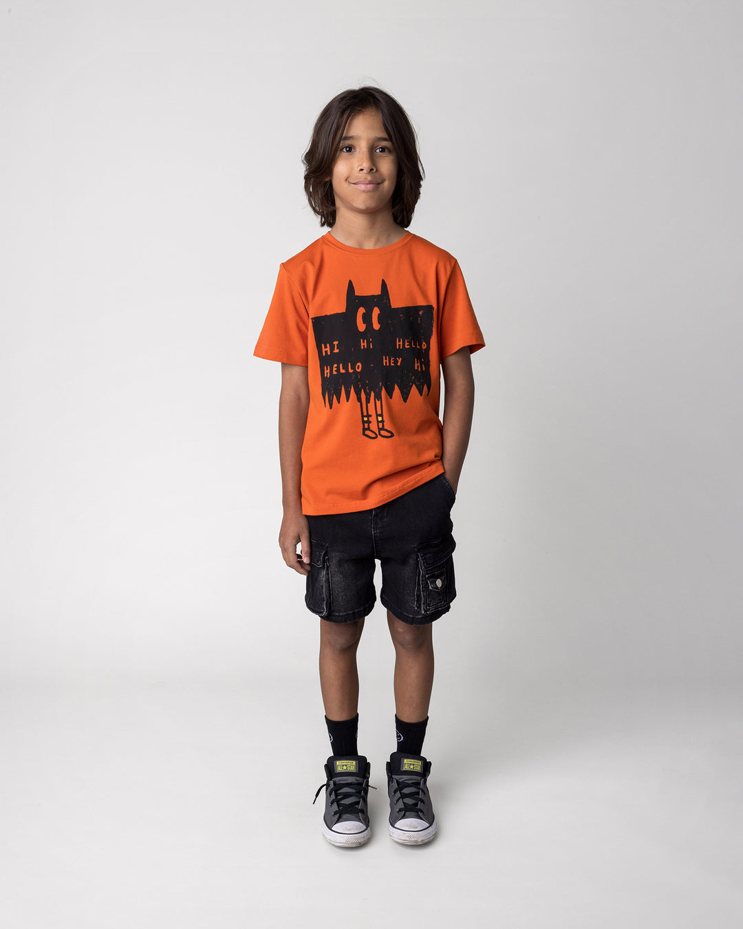 Kid wearing the Greetings Bat Tee in orange, front view