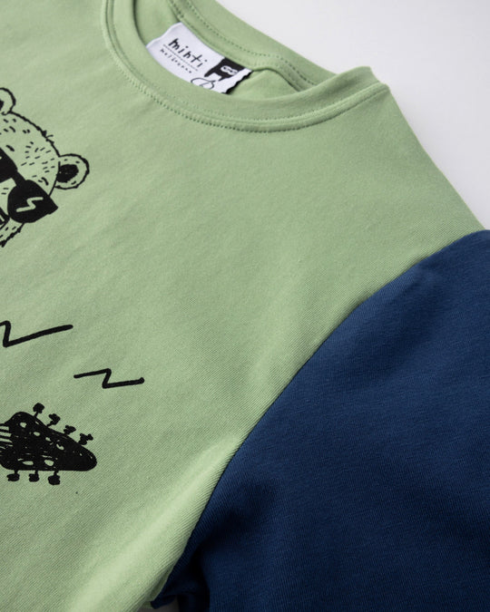 Close up detail of the Grizzly Tee in sage, yellow and midnight