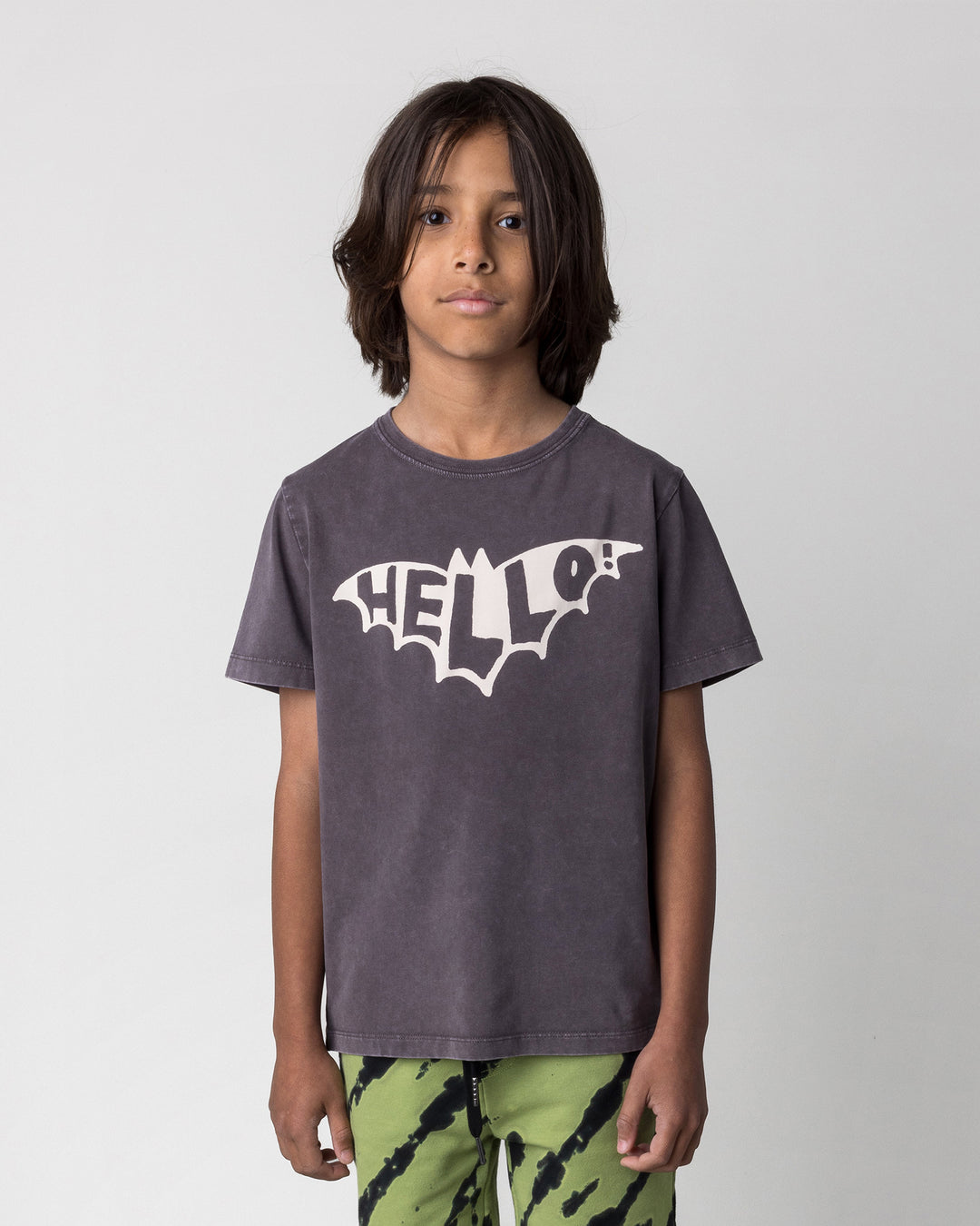 Close up of the Hello Bat Tee in black wash on a kid, front view