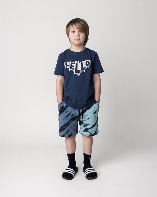 Kid wearing the Hello Bat Tee in ink with the Duo Tie Dye Short in blue and aqua, front view