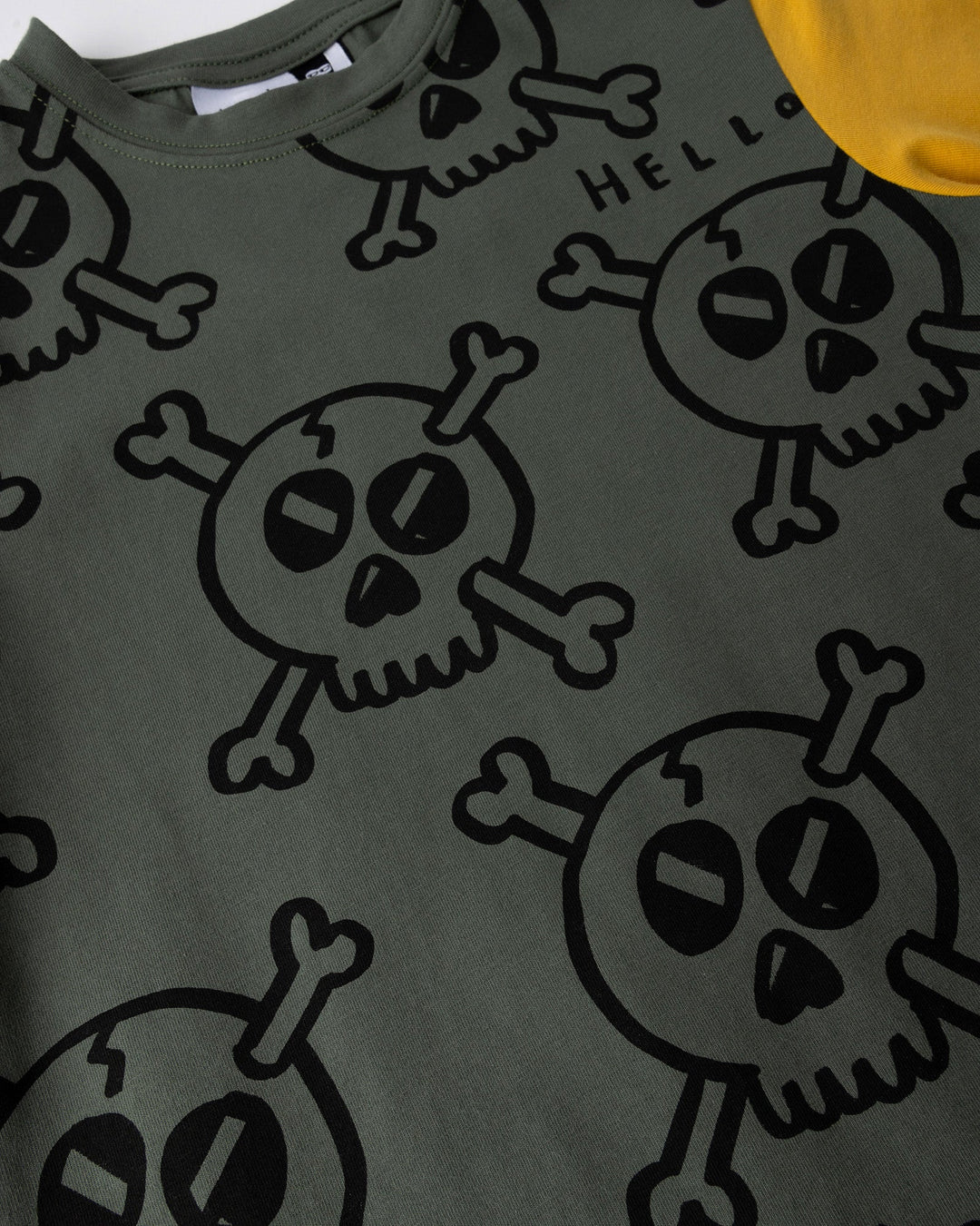 Close up of the Hello Skull Tee print in forest, dark grey and yellow