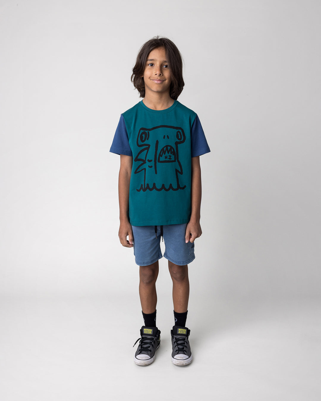 Kid wearing the Hi Hammerhead Tee in dark teal and midnight with the Blasted Deluxe Cargo Short in midnight wash, front view