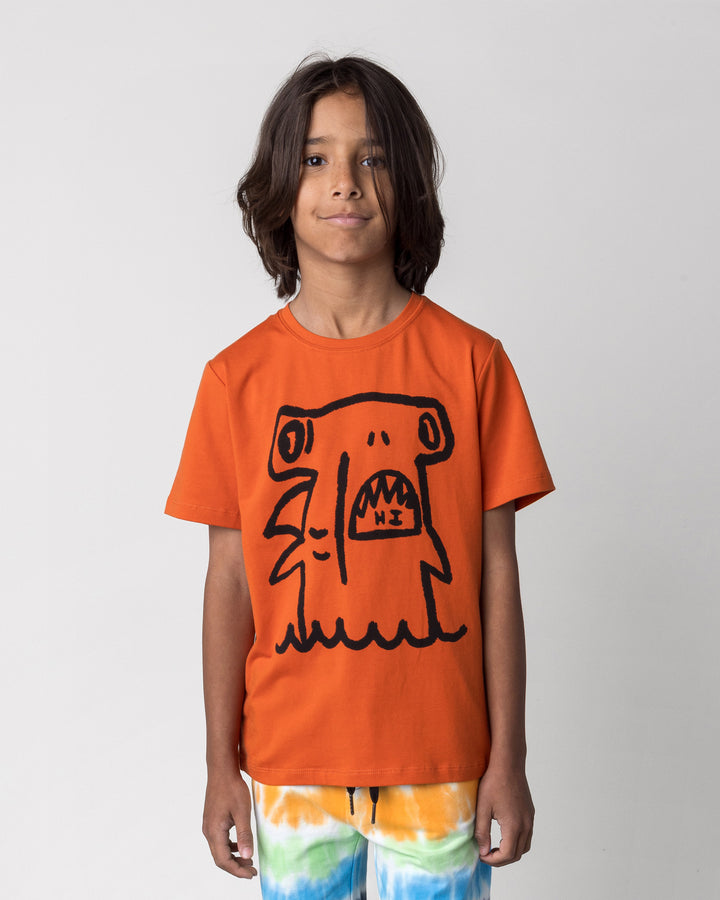 Close up of the Hi Hammerhead Tee in orange on a kid, front view