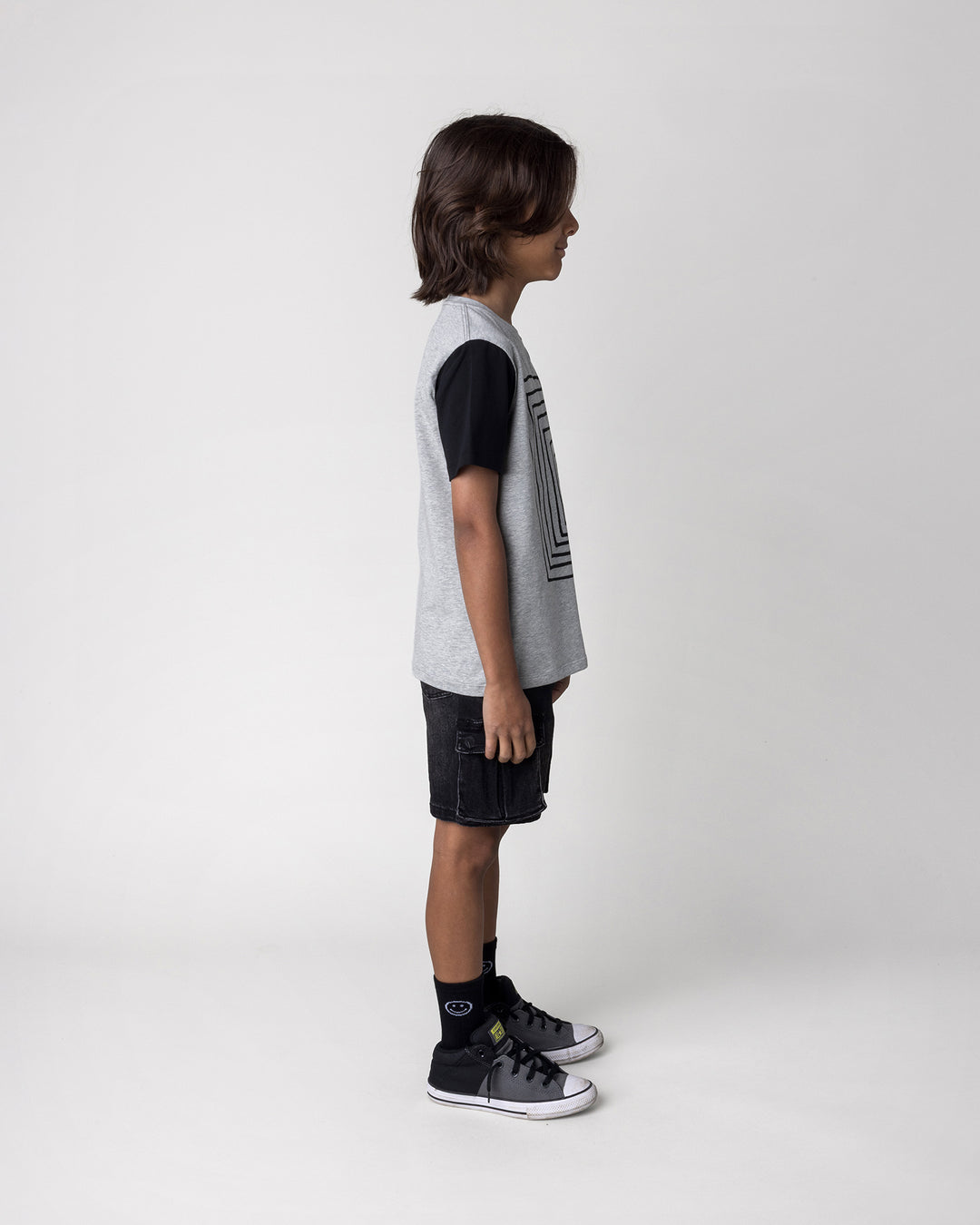 Kid wearing the Hidden Panda Tee in grey marle and black, side view