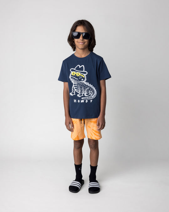 Kid wearing the Howdy Lizard Tee in ink with the Splatter Short in orange, front view