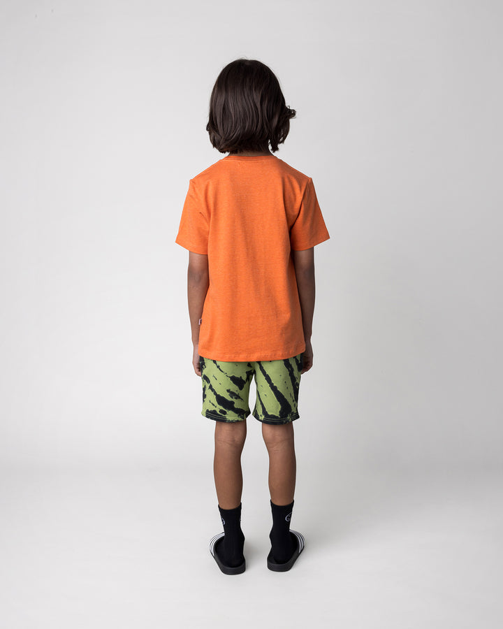 Kid wearing the Howdy Lizard Tee in orange marle with the Strike Short in lime, back view