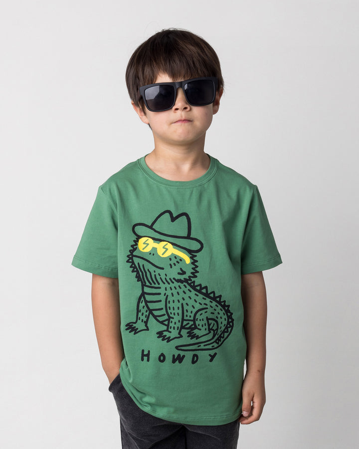 Close up of the Howdy Lizard Tee in turf on a kid, front view