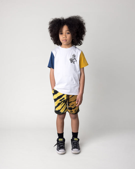 Kid wearing the Hi Pigeon Tee in white, midnight and yellow with the Duo Tie Dye Short in lemon and rust, front view