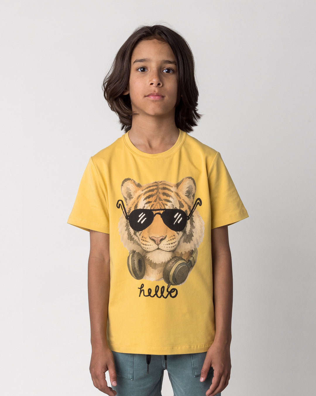 Close up of the Headphones Tiger Tee in dull yellow on a kid, front view