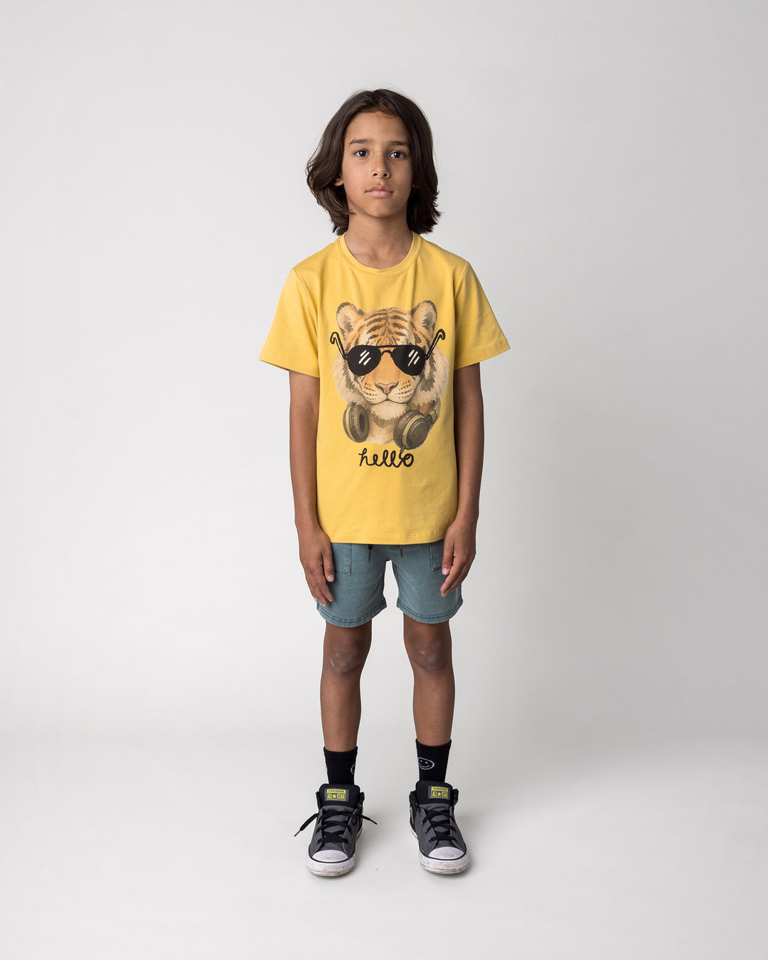 Kid wearing the Headphones Tiger Tee in dull yellow with the Blasted Track Short in forest wash, front view
