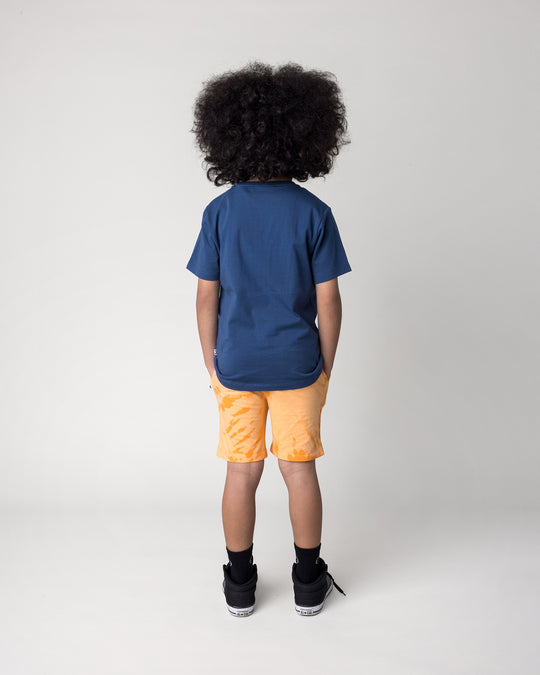 Kid wearing the Headphones Tiger Tee in midnight with the Splatter Short in orange, back view
