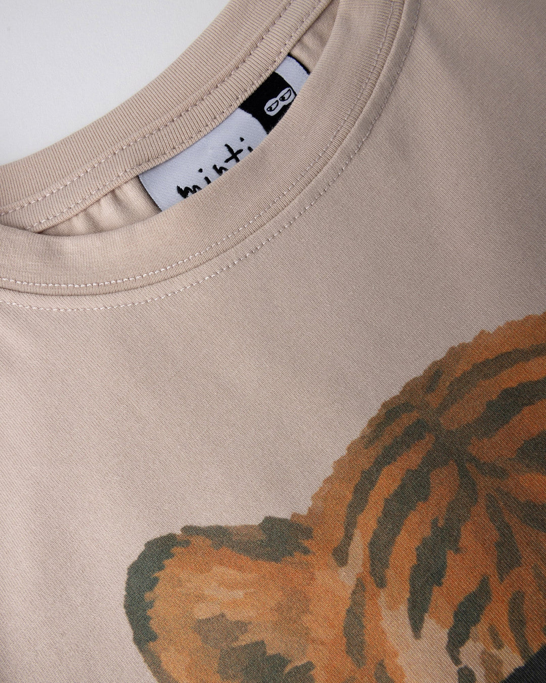 Close up detail of the Headphones Tiger Tee in stone