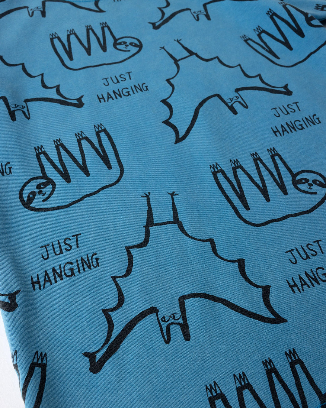 Close up of the Just Hanging Tee print in sky wash