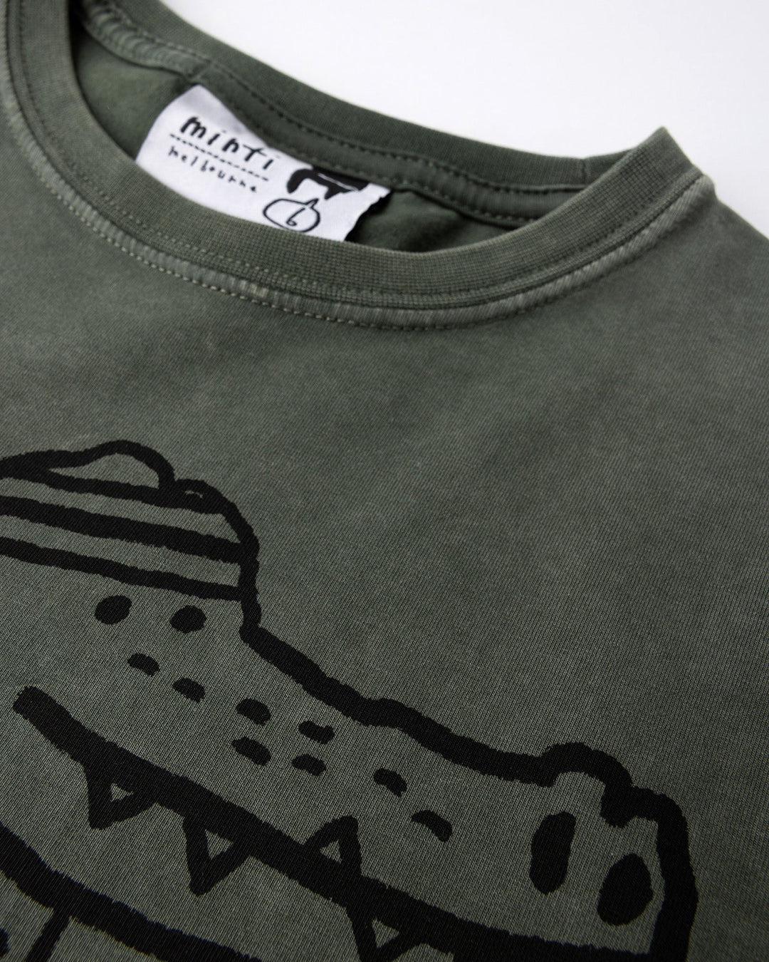 Close up of the Later Gator Tee print in olive wash