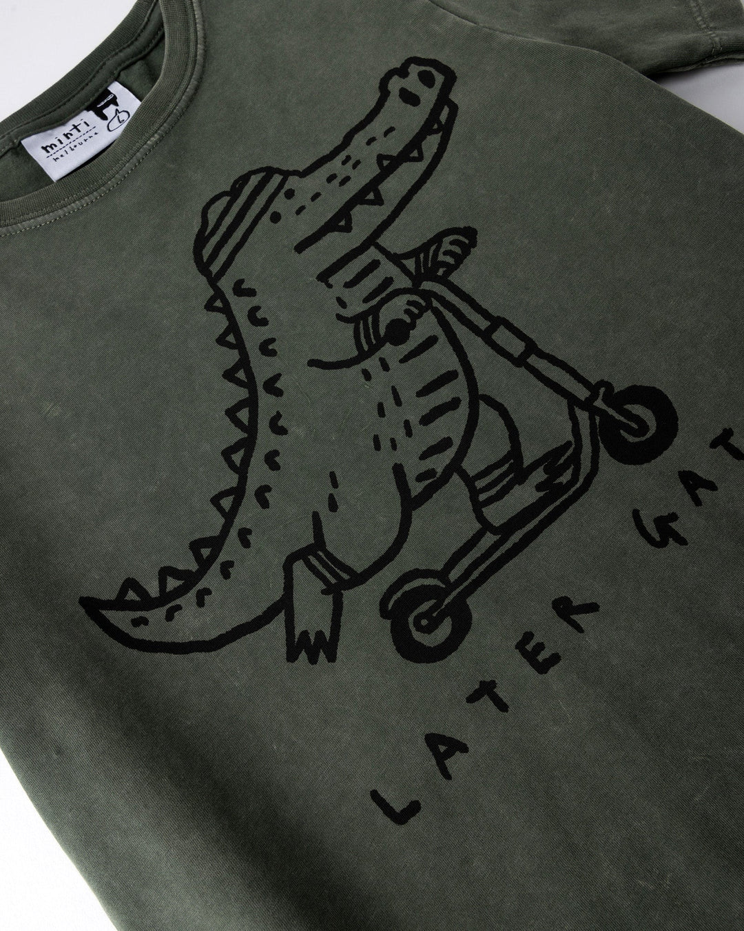 Close up of the Later Gator Tee print in olive wash