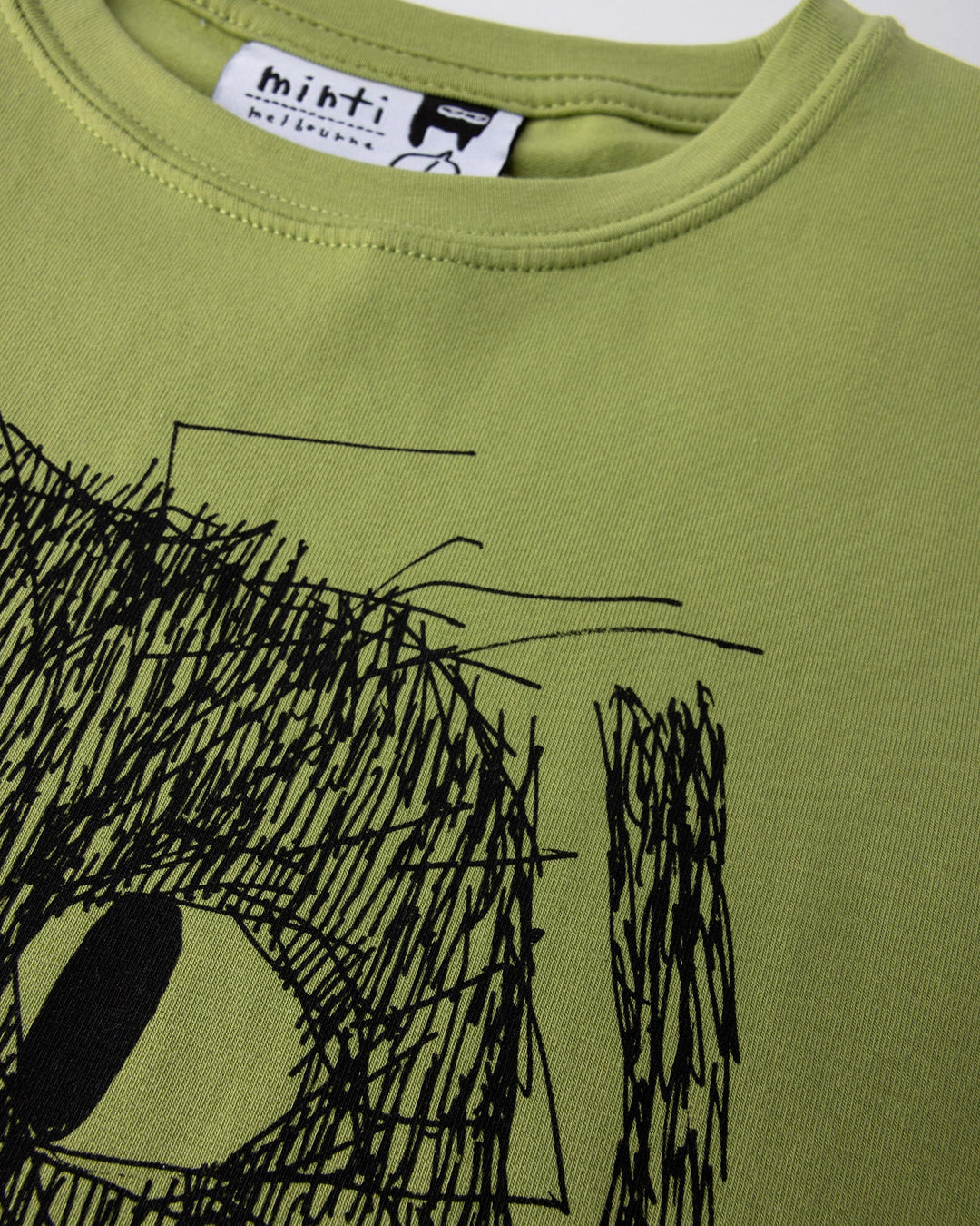 Close up of the Messy Monster Tee print in lime