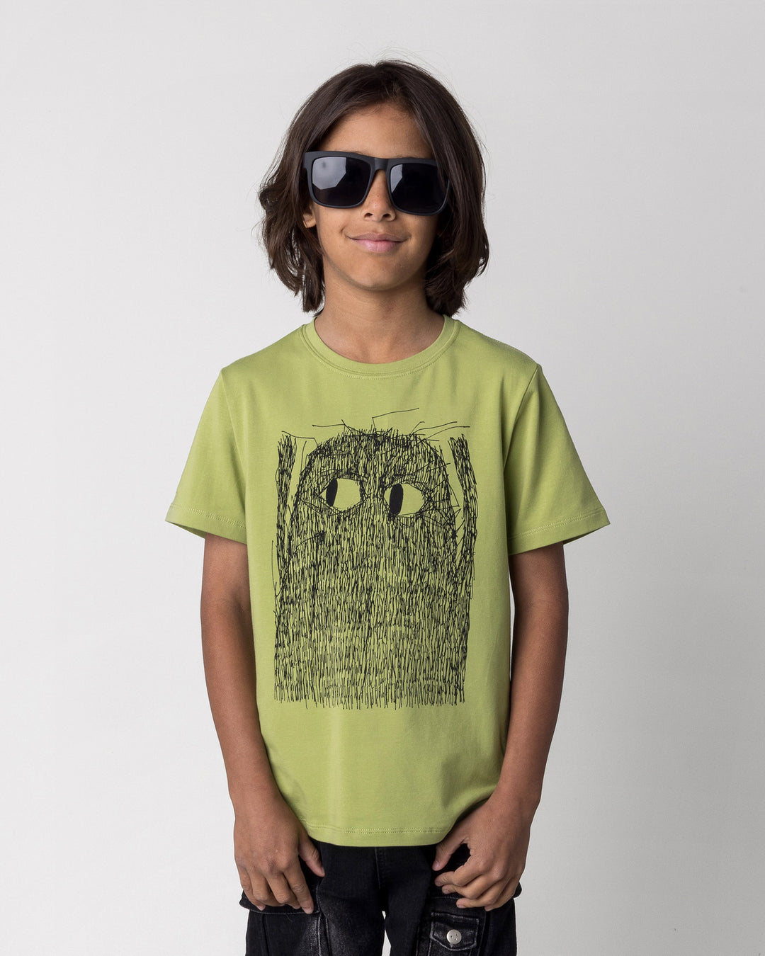 Close up of the Messy Monster Tee in lime on a kid, front view