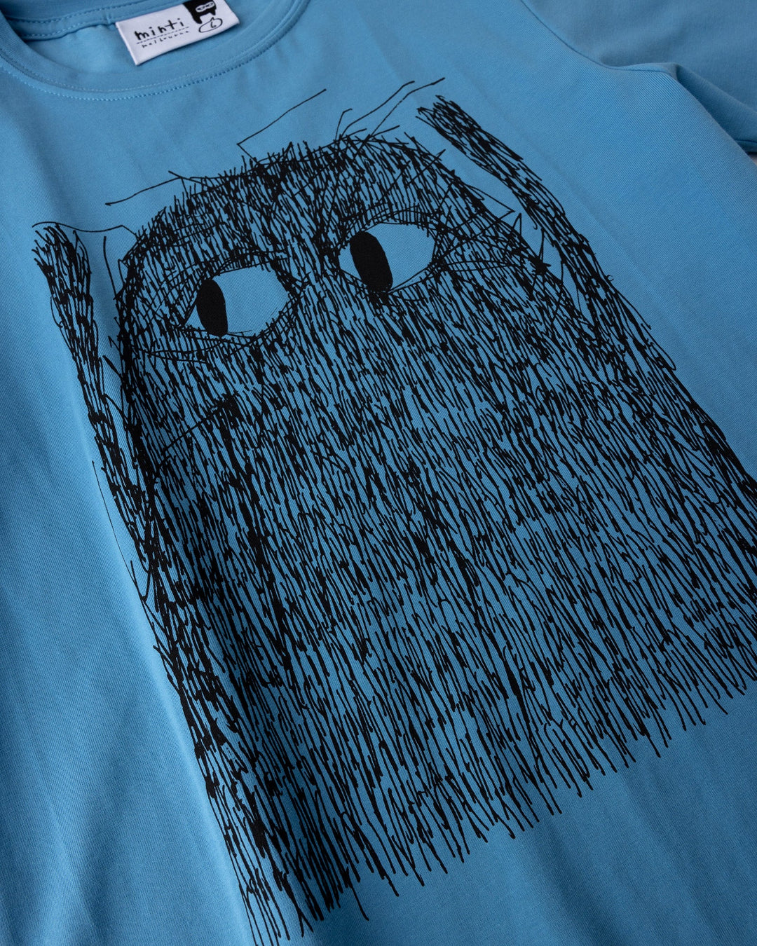 Close up of the Messy Monster Tee print in steel